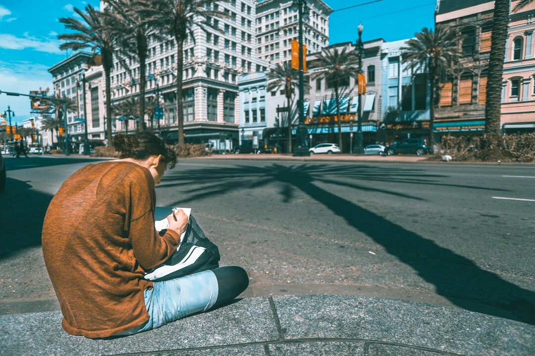 Urban researcher reviewing city photographs on a laptop