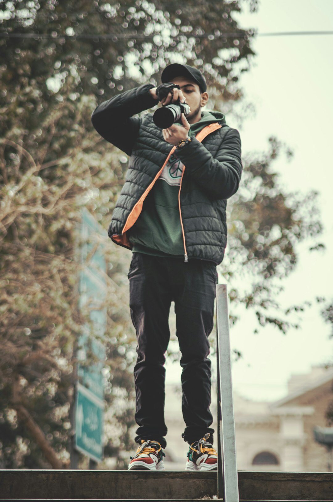 Portrait of a young Chilean street photographer holding a camera